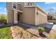Two-story home features charming curb appeal with flower beds and lush green lawn at 21950 E Crestline Ln, Aurora, CO 80015