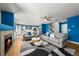Open-concept living room featuring hardwood floors, a fireplace, and lots of natural light at 21950 E Crestline Ln, Aurora, CO 80015