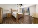Primary bedroom featuring wood-look flooring, and bright windows with lovely curtains at 21950 E Crestline Ln, Aurora, CO 80015