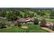 An aerial view of a luxurious golf course, showcasing the manicured greens, elegant clubhouse, and a serene pond at 6931 W 75Th Pl, Arvada, CO 80003