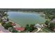 Wonderful aerial view of neighborhood homes near a beautiful lake and green spaces with mature trees and walking paths at 6931 W 75Th Pl, Arvada, CO 80003