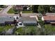 Aerial view of a backyard patio featuring an umbrella-covered dining table and a well-manicured lawn at 6931 W 75Th Pl, Arvada, CO 80003
