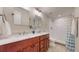 This bathroom has double sinks and a shower with white subway tile at 6931 W 75Th Pl, Arvada, CO 80003