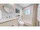 This bathroom has a tub with a shower, a sink, and a mirror at 6931 W 75Th Pl, Arvada, CO 80003