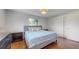 This bedroom boasts a large bed, beautiful hardwood floors, and a light and airy feel at 6931 W 75Th Pl, Arvada, CO 80003