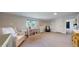 This bedroom has carpet, a crib, a chair, and a dresser at 6931 W 75Th Pl, Arvada, CO 80003