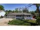 A charming single-story home with a well-manicured lawn, front porch and a two-car garage, offering a cozy and inviting curb appeal at 6931 W 75Th Pl, Arvada, CO 80003