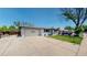 Exterior shot of home with a two-car garage and long driveway at 6931 W 75Th Pl, Arvada, CO 80003