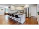 Modern kitchen with breakfast bar seating, stainless appliances, and ample counter space at 6931 W 75Th Pl, Arvada, CO 80003