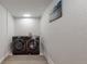 A modern laundry room features side-by-side washer and dryer at 6931 W 75Th Pl, Arvada, CO 80003