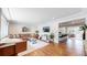 Open-concept living room with hardwood floors, a comfortable sectional sofa, and a view into the kitchen at 6931 W 75Th Pl, Arvada, CO 80003