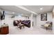 Living room features a large sectional sofa, a coffee table, and a television on the wall at 6931 W 75Th Pl, Arvada, CO 80003