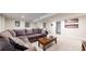 Living room featuring a sectional sofa, a coffee table, and framed pictures on the wall at 6931 W 75Th Pl, Arvada, CO 80003