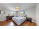 Serene bedroom with hardwood flooring and comfortable bedding with lots of natural light at 6931 W 75Th Pl, Arvada, CO 80003