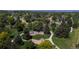 Aerial view of a neighborhood park featuring playground equipment, mature trees, and walking paths for community enjoyment at 6931 W 75Th Pl, Arvada, CO 80003