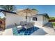 Back patio area with patio furniture set and decorative blue rug at 6931 W 75Th Pl, Arvada, CO 80003