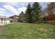 Large grassy backyard with mature trees and a fenced perimeter at 2610 Heidelberg Dr, Boulder, CO 80305