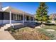 Eye-level view of the home's front exterior and front porch, featuring a professionally landscaped yard at 2610 Heidelberg Dr, Boulder, CO 80305