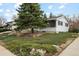 Charming single-story home with mature landscaping featuring a mature evergreen tree at 2610 Heidelberg Dr, Boulder, CO 80305