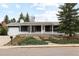 Inviting home exterior featuring a well-maintained front yard and a welcoming covered front porch at 2610 Heidelberg Dr, Boulder, CO 80305