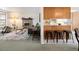 Open concept living room and kitchen with wood cabinets, granite countertops, and bar stool seating at 2610 Heidelberg Dr, Boulder, CO 80305