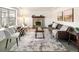 Cozy living room with brick fireplace, neutral decor, and large window with backyard views at 2610 Heidelberg Dr, Boulder, CO 80305