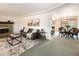 Open concept living area flowing into a dining space, enhanced by a stylish brick fireplace feature at 2610 Heidelberg Dr, Boulder, CO 80305