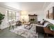 Inviting living room with a cozy brick fireplace, neutral palette, and a bright bay window at 2610 Heidelberg Dr, Boulder, CO 80305