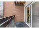 A balcony with brick wall and view to the sliding doors and the condo interior at 14652 E 2Nd Ave # 200D, Aurora, CO 80011