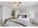 Comfortable bedroom with a decorative ceiling fan, neutral paint, and soft accent pillows at 14652 E 2Nd Ave # 200D, Aurora, CO 80011