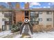 Exterior view of a condo complex with a walkway, brick accents, and unit entrances at 14652 E 2Nd Ave # 200D, Aurora, CO 80011