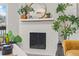 Close-up of the fireplace with plants, decor and a mirror at 14652 E 2Nd Ave # 200D, Aurora, CO 80011