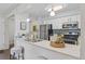 Bright kitchen featuring stainless steel appliances, breakfast bar seating, and modern backsplash at 14652 E 2Nd Ave # 200D, Aurora, CO 80011