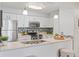 Well-lit kitchen with stainless appliances, white cabinets, and bar with stool seating at 14652 E 2Nd Ave # 200D, Aurora, CO 80011