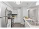 Bright kitchen with modern appliances, breakfast bar seating, and updated countertops at 14652 E 2Nd Ave # 200D, Aurora, CO 80011