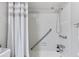 Clean shower with a shower curtain, grab bar, and updated fixtures at 14652 E 2Nd Ave # 200D, Aurora, CO 80011