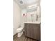 Powder bathroom with a wood vanity, modern fixtures, and neutral wall paint at 4537 N Tennyson St # 101, Denver, CO 80212