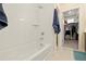 Bathroom featuring bathtub, tile surround, and access to walk-in closet at 4537 N Tennyson St # 101, Denver, CO 80212