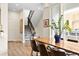 Bright dining area with modern wood table, seating, and staircase in an open concept space at 4537 N Tennyson St # 101, Denver, CO 80212