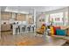 Open-concept with lots of light, an island with seating and views to the dining and living area at 4537 N Tennyson St # 101, Denver, CO 80212