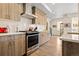 Modern kitchen with stainless steel appliances, white countertops, and wood cabinets at 4537 N Tennyson St # 101, Denver, CO 80212