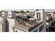 Relaxing rooftop patio with outdoor furniture, flowers, and an umbrella for shade at 4537 N Tennyson St # 101, Denver, CO 80212