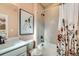 Stylish bathroom featuring a tub with decorative curtain, artistic touches, and modern fixtures at 1759 Peak Loop, Broomfield, CO 80023