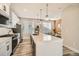 Spacious kitchen with a large island, modern appliances, and an open layout leading to the dining area at 1759 Peak Loop, Broomfield, CO 80023