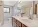 Bathroom with tile floor and double sink vanity with framed mirror and shower with tile surround at 280 Pierce St, Erie, CO 80516