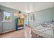 Bright bedroom with light blue walls, hardwood floor, colorful cabinet and plenty of natural light at 280 Pierce St, Erie, CO 80516