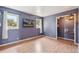 Cozy bedroom featuring wood floors, closet, flat screen TV and natural light from two windows at 280 Pierce St, Erie, CO 80516