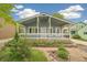 Charming blue bungalow features a covered porch, updated landscaping and a basketball hoop at 280 Pierce St, Erie, CO 80516