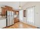 Bright kitchen features wood floors, stainless refrigerator, and natural light at 280 Pierce St, Erie, CO 80516