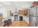 Eat in kitchen features stainless appliances, a breakfast bar, and wood floors at 280 Pierce St, Erie, CO 80516